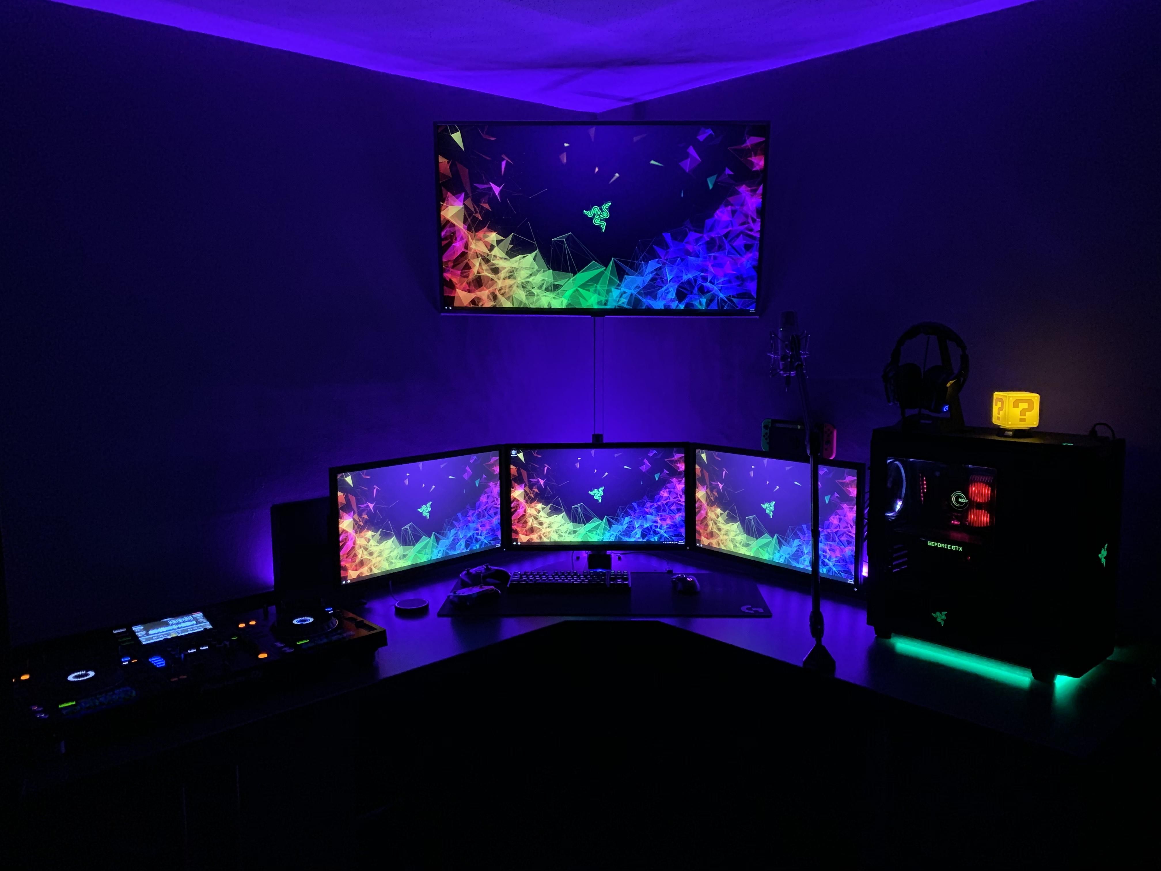 Atmospheric gaming rig glowing in a dark room